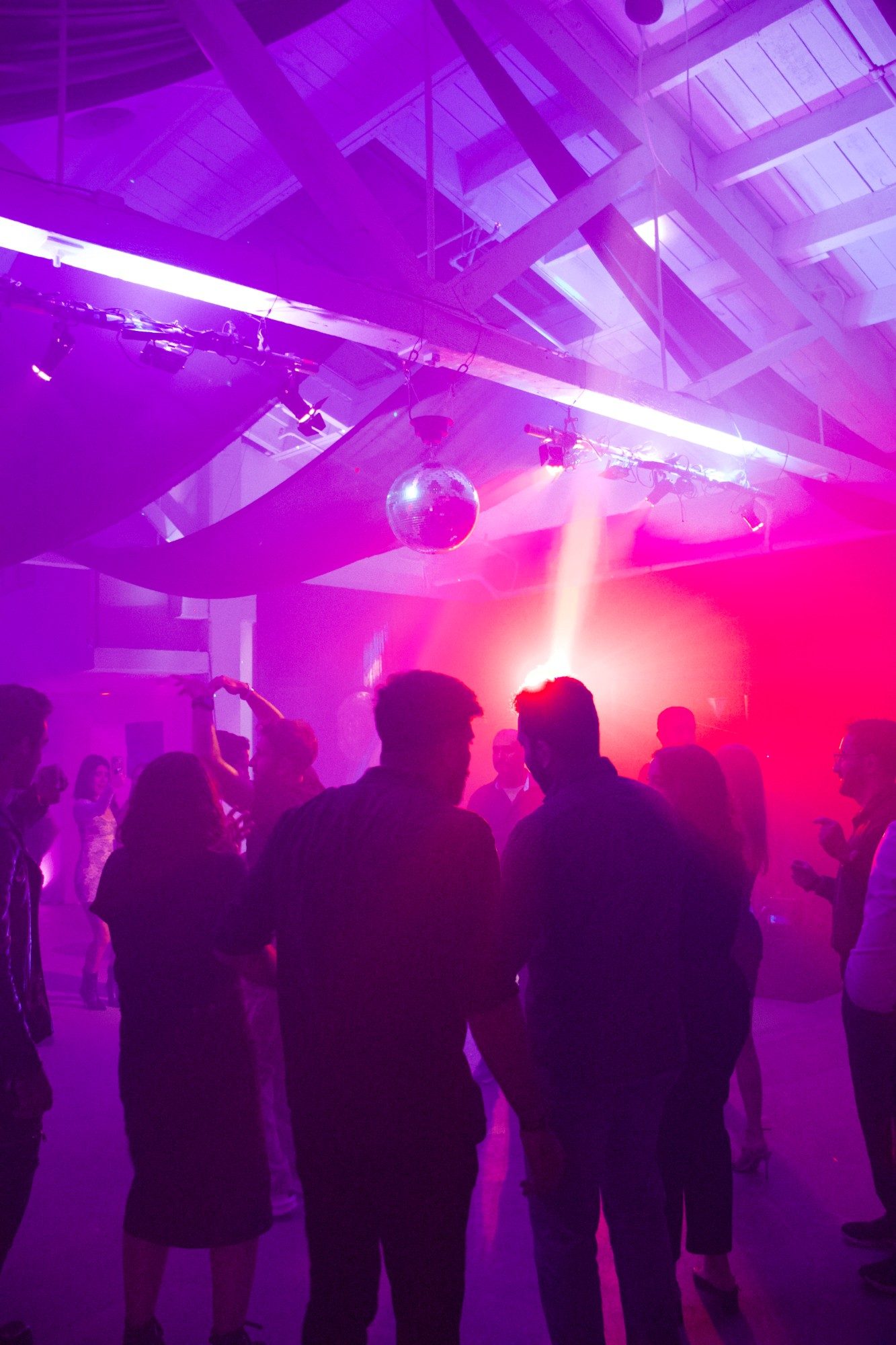 Packed dance floor with disco ball at a Bay Area party