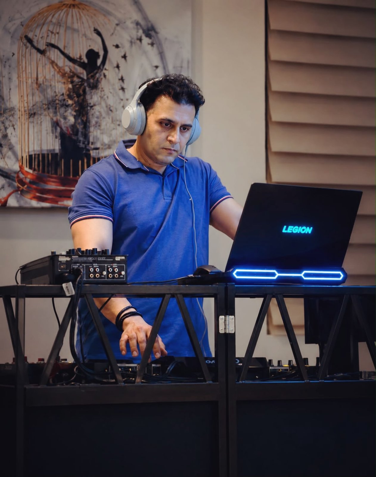 DJ Alphire mixing on his laptop and controller setup.