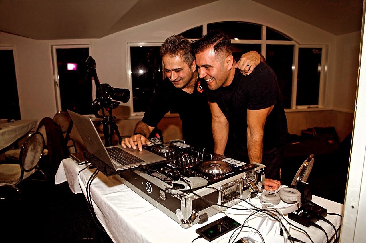 DJ Alphire and a fellow DJ mixing together at a wedding reception