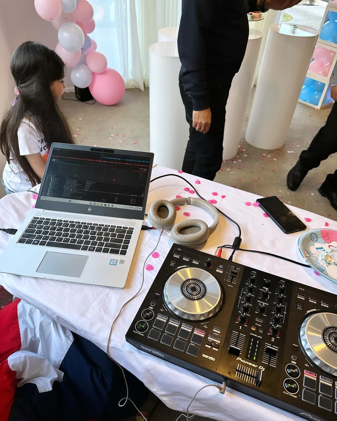 DJ Alphire's Pioneer DJ Serato controller and setup at a balloon-decorated party.
